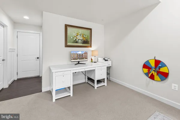 a workspace with furniture wall paintings and a window