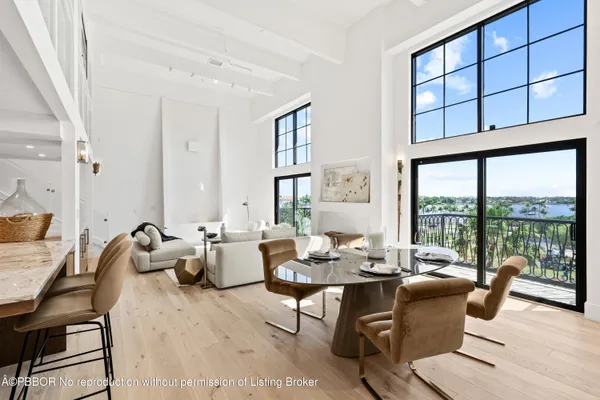 a living room with furniture and large windows
