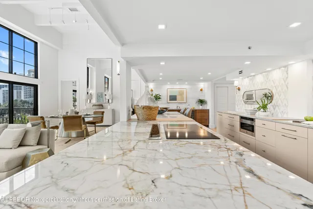 a large white kitchen with cabinets