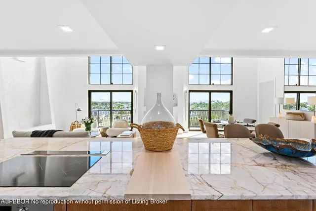 a living room with furniture and large windows