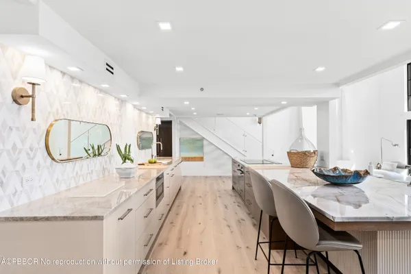 a kitchen with stainless steel appliances granite countertop a sink and a refrigerator