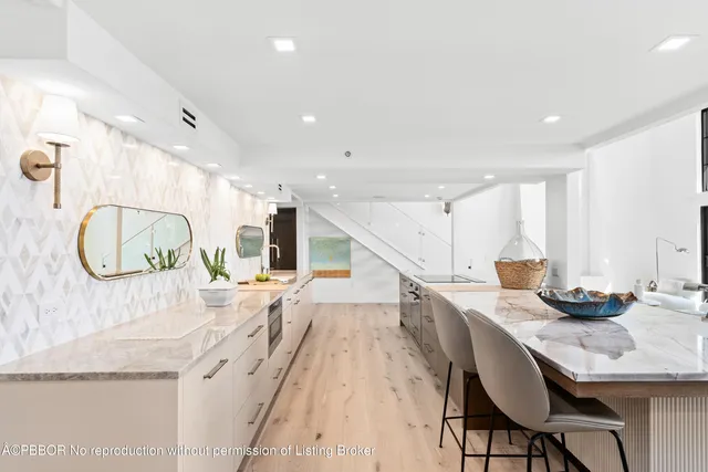 a kitchen with stainless steel appliances granite countertop a sink and a refrigerator