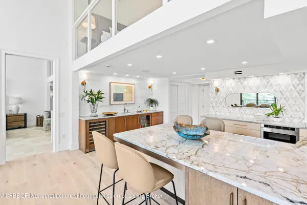 a kitchen with granite countertop a counter top space and stainless steel appliances