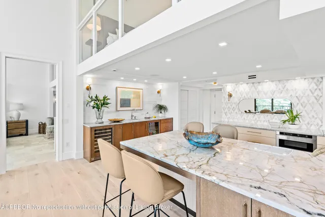 a kitchen with granite countertop a counter top space and stainless steel appliances