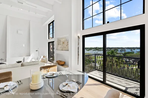 a living room with furniture and a floor to ceiling window