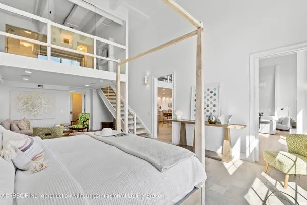 a bedroom with a bed a table and chair