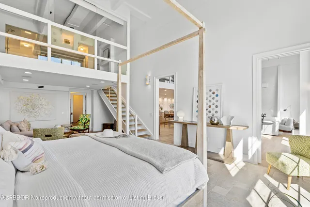 a bedroom with a bed a table and chair