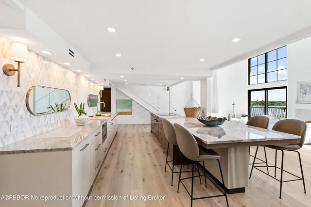 a large kitchen with lots of counter space and windows