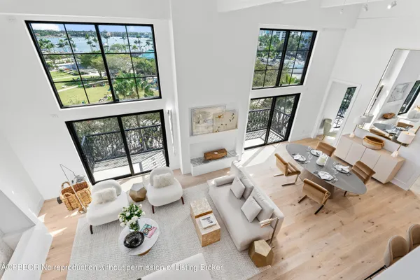 a living room with furniture and floor to ceiling windows