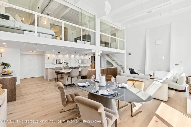 a living room with lots of furniture and view of kitchen