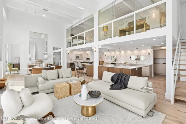 a living room with furniture and view of kitchen