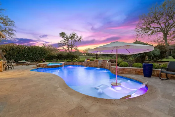 a view of a swimming pool with lounge chairs