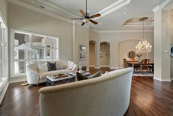 a living room with furniture and a chandelier