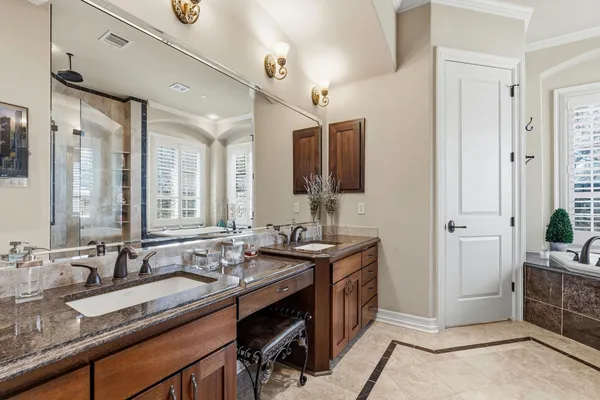 a bed sitting in a bedroom next to a large window