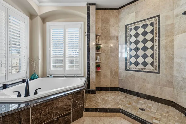a bathroom with double vanity and a bathtub