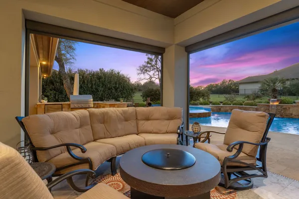 a balcony with furniture and a fire pit