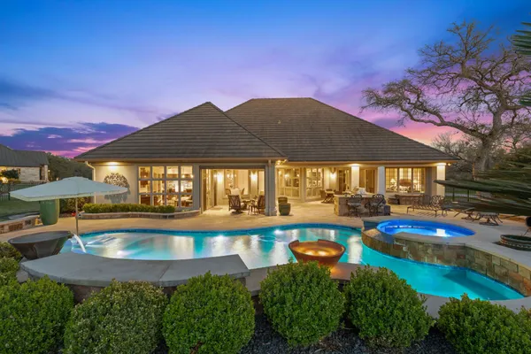 a view of a swimming pool with lounge chairs in patio