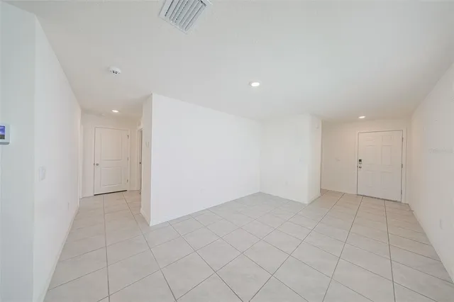 an empty room with white walls and tiles