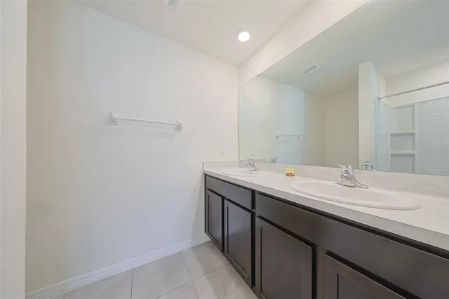 a view of bathroom with double sink and mirror