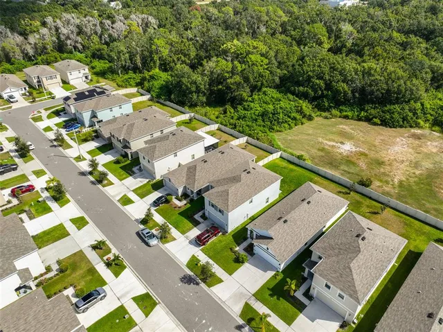 an aerial view of a house with a yard