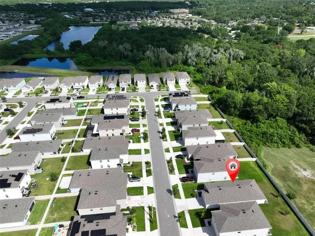 an aerial view of residential houses with outdoor space