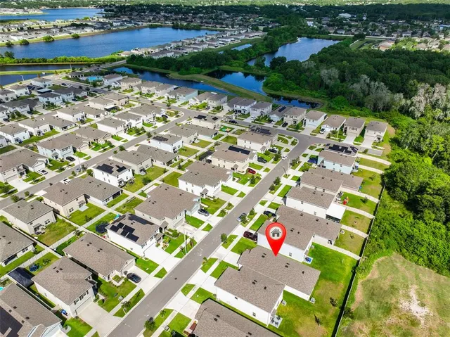 an aerial view of residential houses with outdoor space and street view