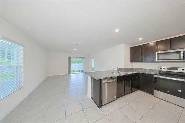 a kitchen with stainless steel appliances granite countertop a sink and stove top oven