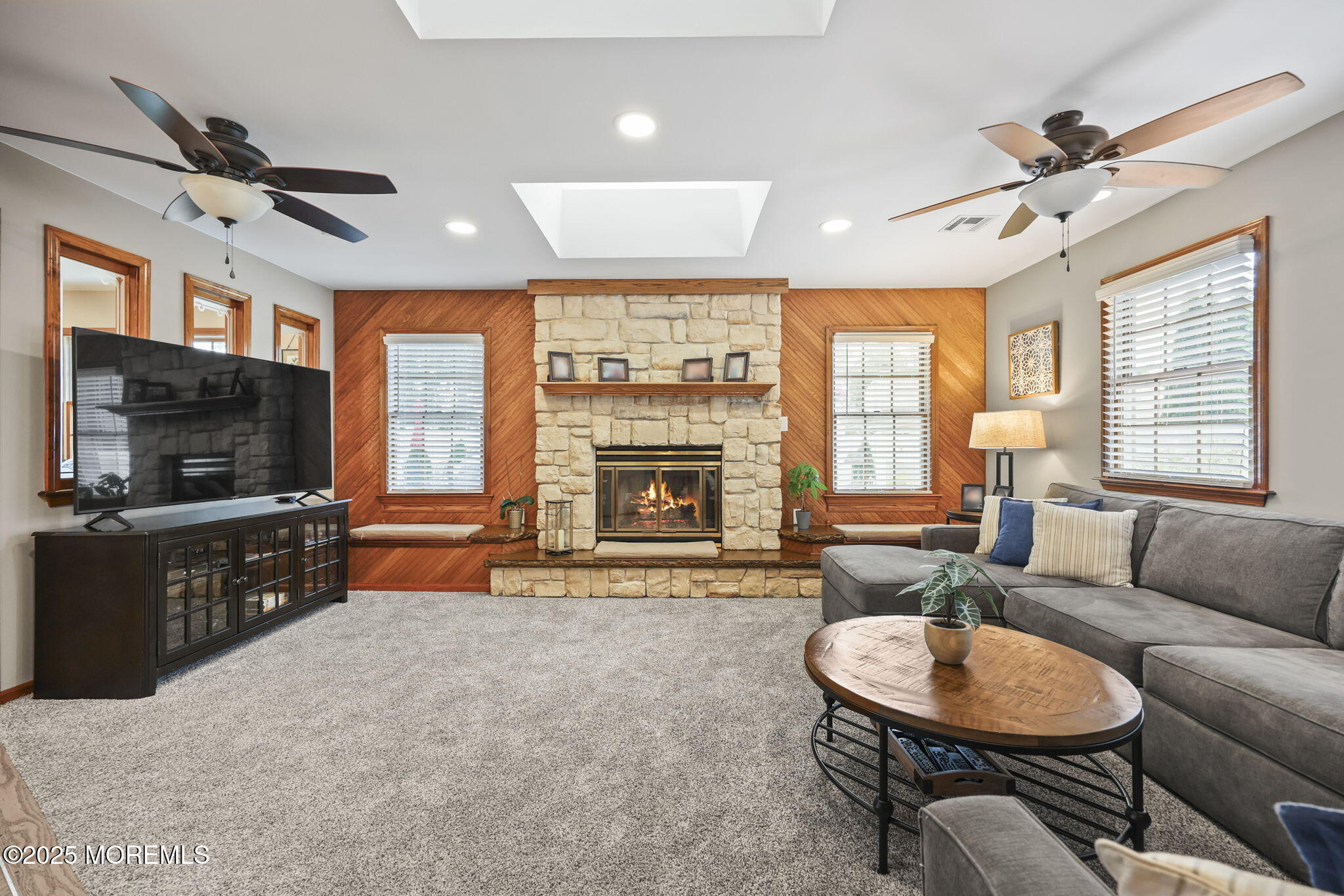67 Appletree Road Howell, NJ 07731 - Photo 24 of 61 a living room with furniture a flat screen tv and a fireplace