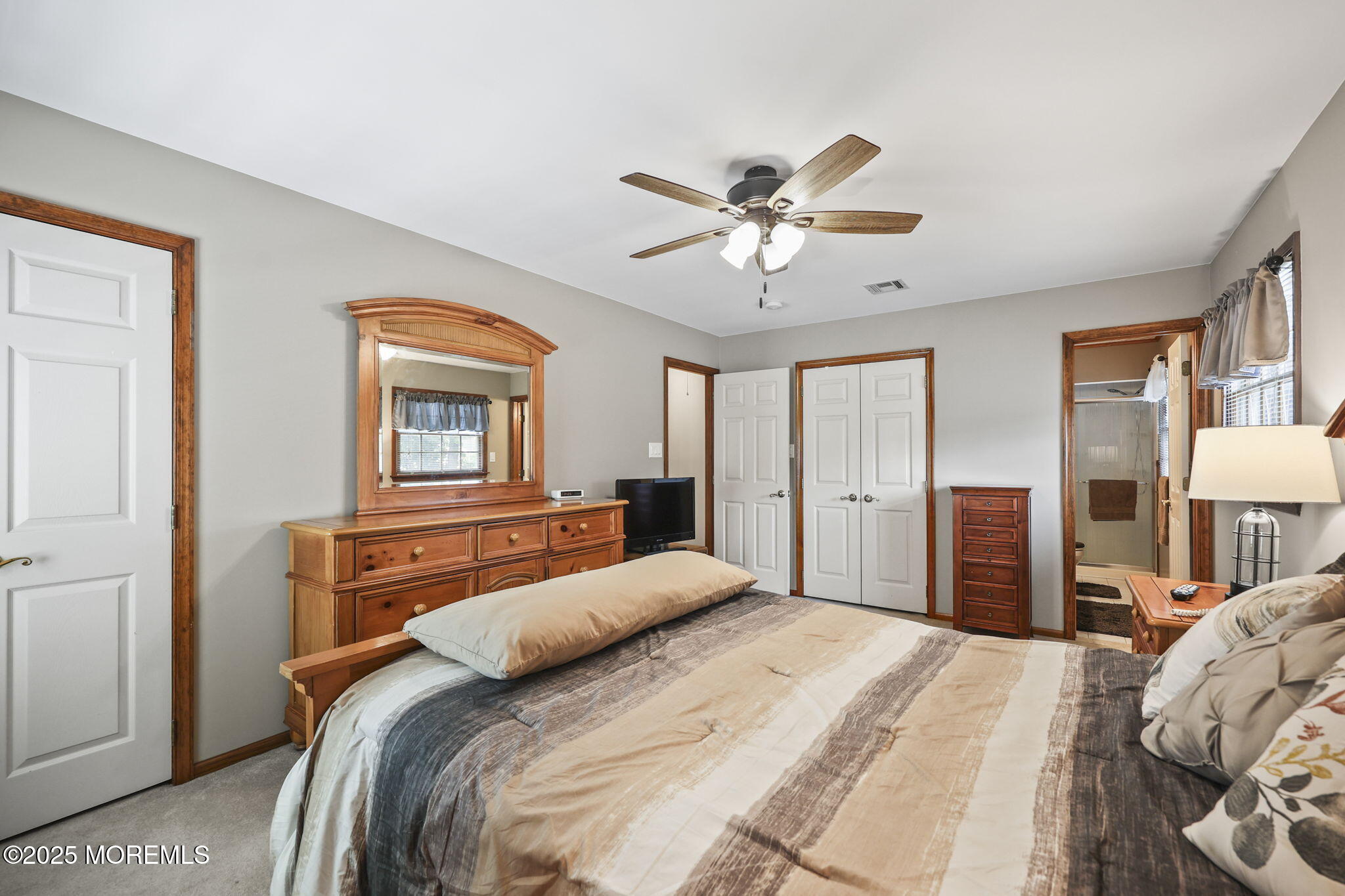 67 Appletree Road Howell, NJ 07731 - Photo 29 of 61 a bedroom with a large bed and a chandelier