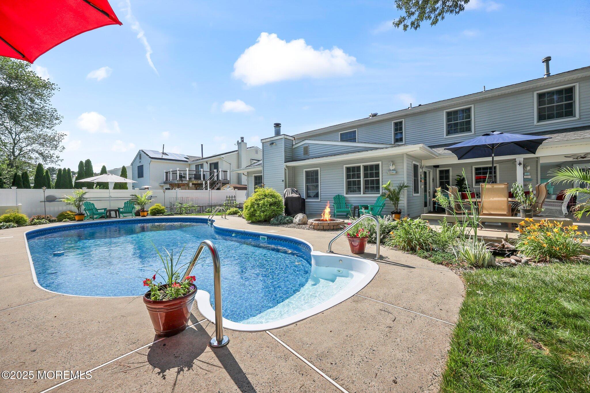 67 Appletree Road Howell, NJ 07731 - Photo 41 of 61 a view of a swimming pool with a patio