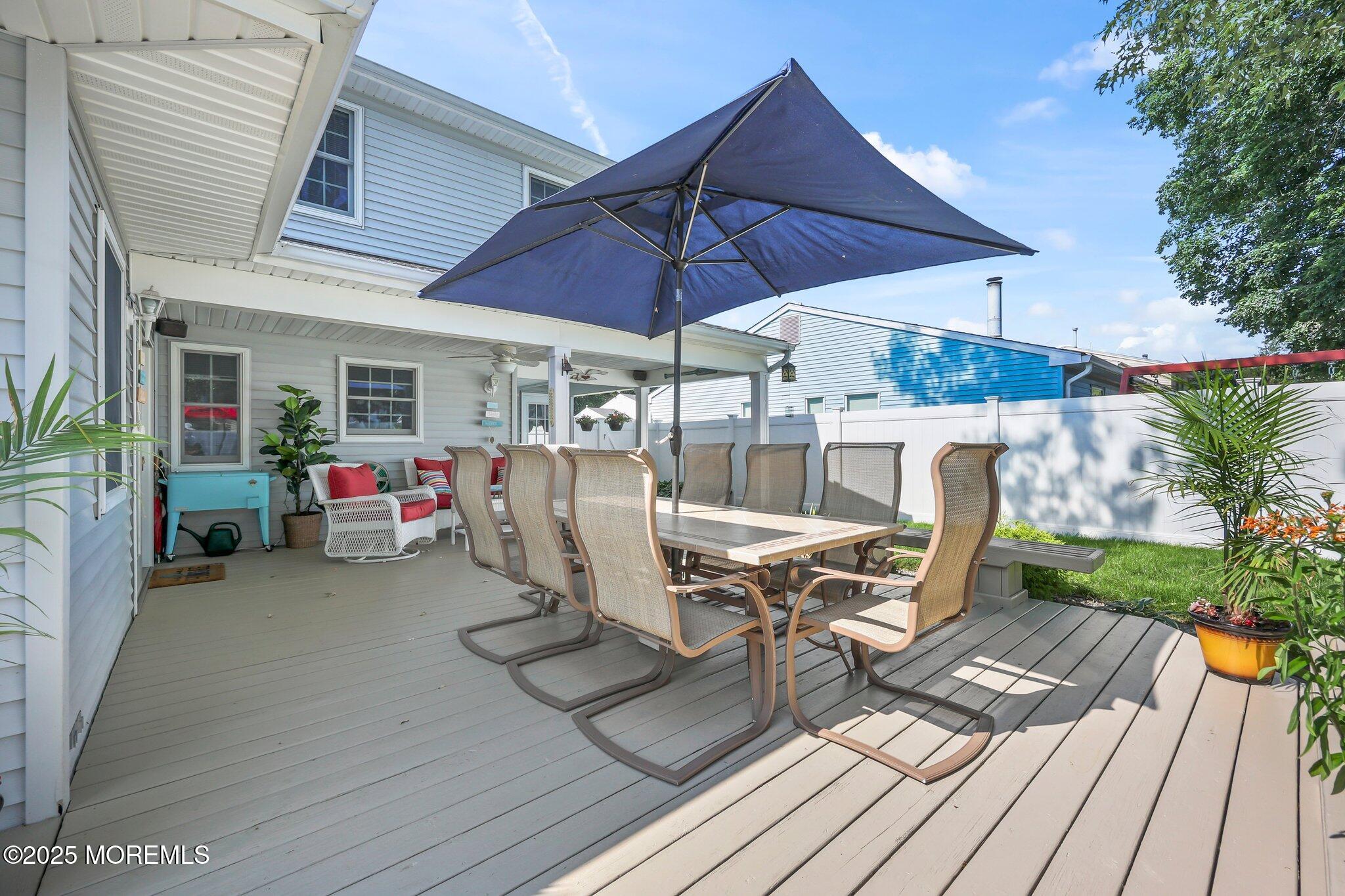 67 Appletree Road Howell, NJ 07731 - Photo 43 of 61 a view of a patio with table and chairs under an umbrella with wooden floor