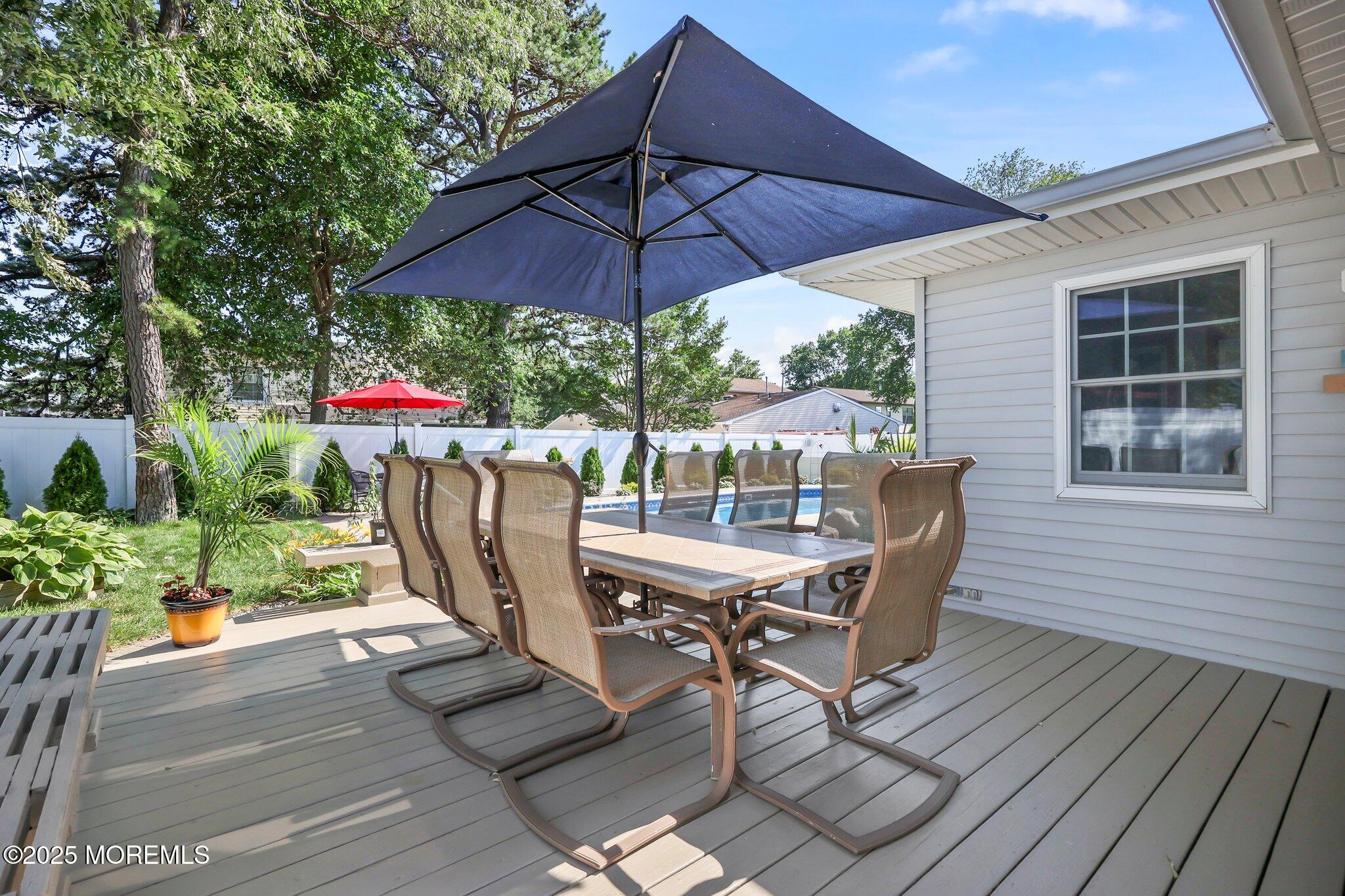 67 Appletree Road Howell, NJ 07731 - Photo 45 of 61 a view of a patio with table and chairs under an umbrella