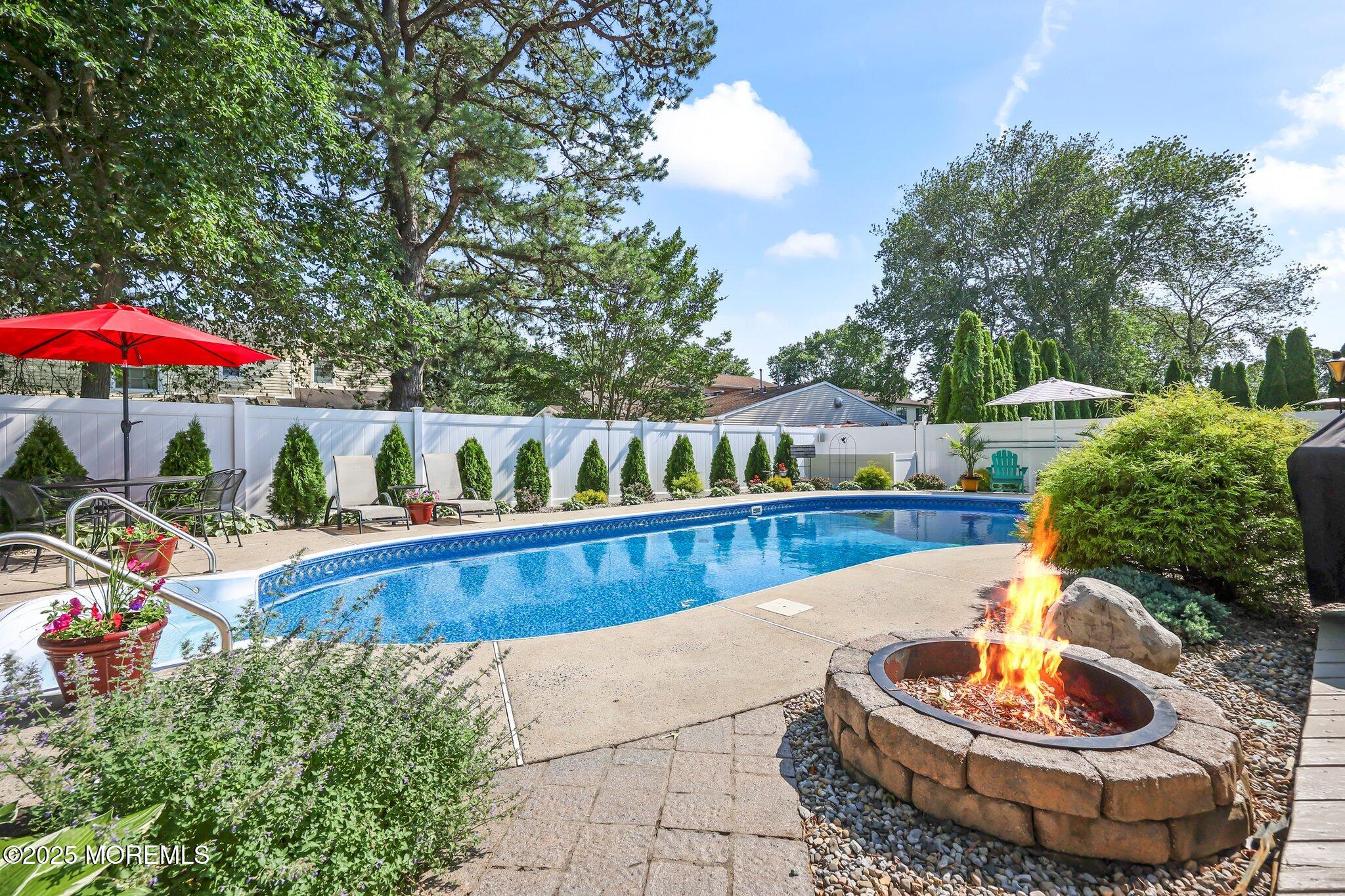 67 Appletree Road Howell, NJ 07731 - Photo 46 of 61 a view of a swimming pool with a patio and a garden