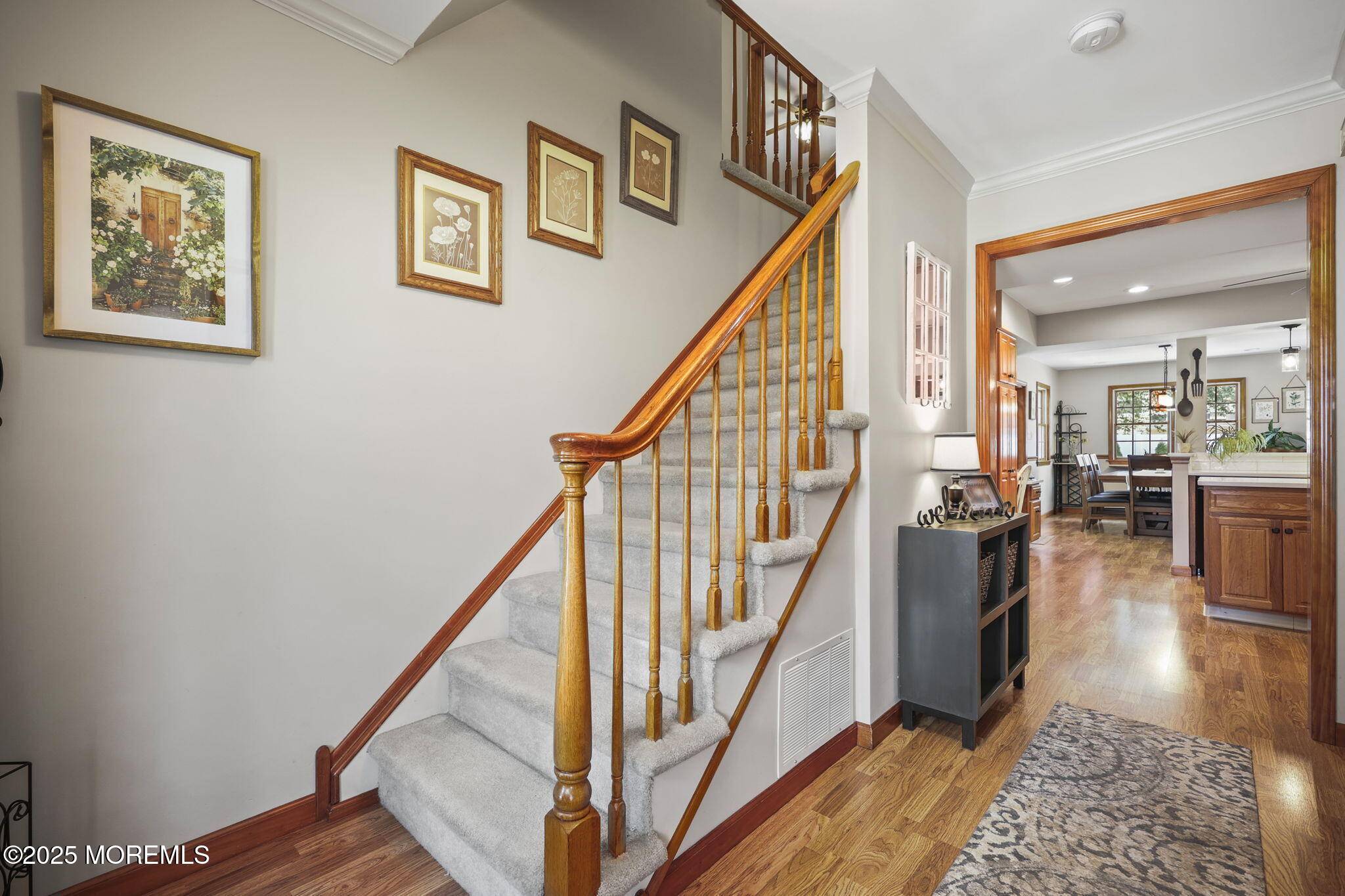 67 Appletree Road Howell, NJ 07731 - Photo 7 of 61 a view of staircase with lots of frames on wall and wooden floor
