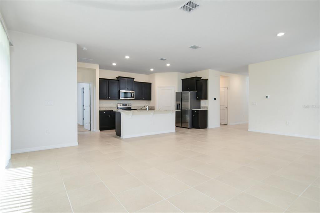 6264 Southwest 89th Ln Road Ocala, FL 34476 - Photo 10 of 22 a view of kitchen with refrigerator stove microwave oven stove and kitchen island