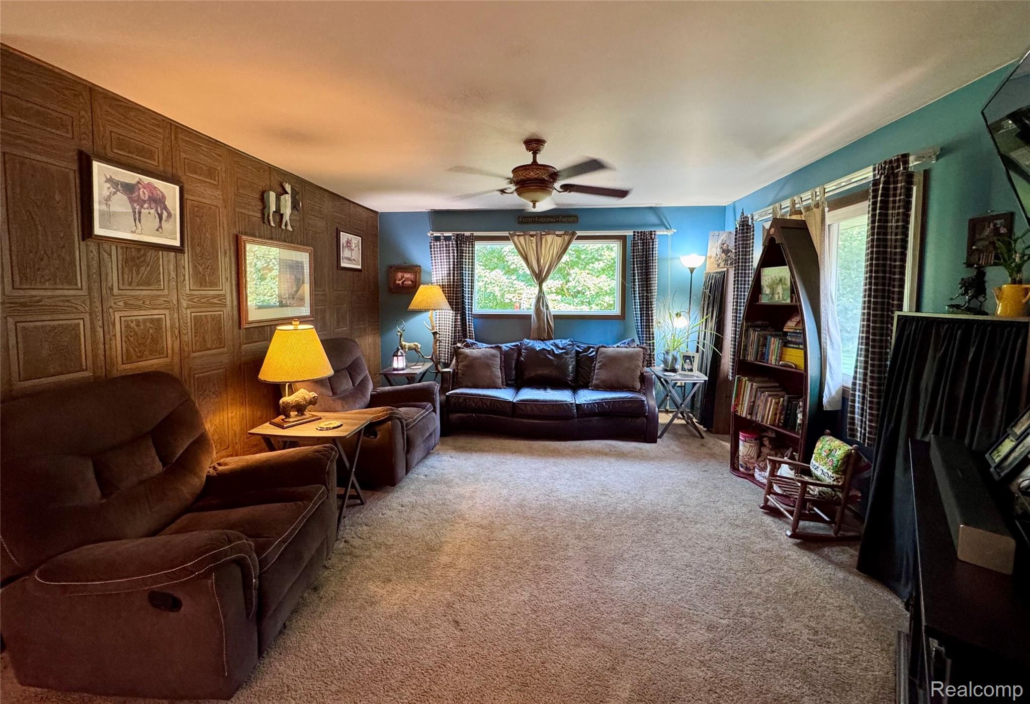 2850 Tin Bill Road Caro, MI 48723 - Photo 3 of 10 Spacious room featuring textured wall paneling, a ceiling fan, and multiple windows