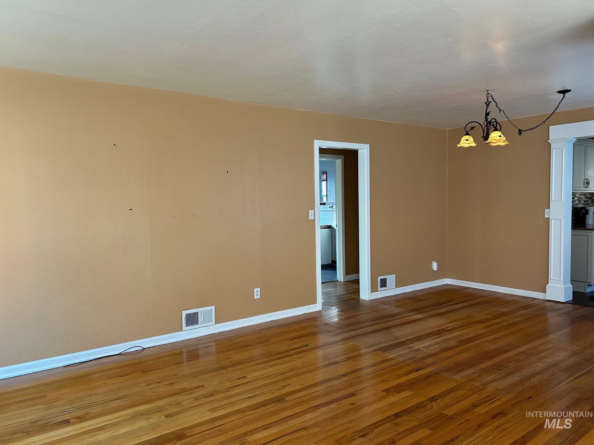112 17th Avenue Lewiston, ID 83501 - Photo 5 of 40 Living area with chandelier and dark wood-type flooring