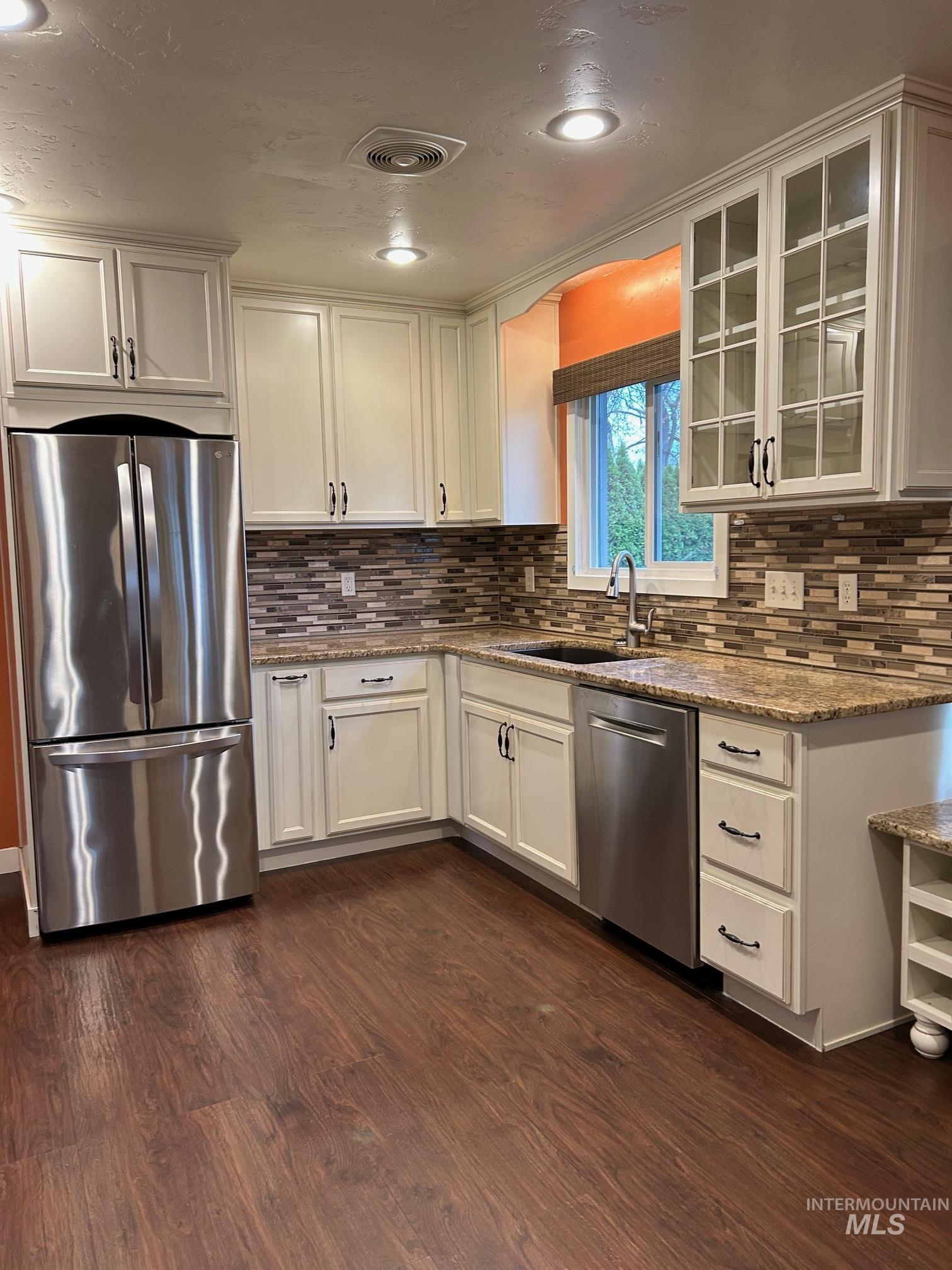 112 17th Avenue Lewiston, ID 83501 - Photo 7 of 40 Kitchen with stainless steel appliances, light stone counters, glass insert cabinets, white cabinetry, and recessed lighting