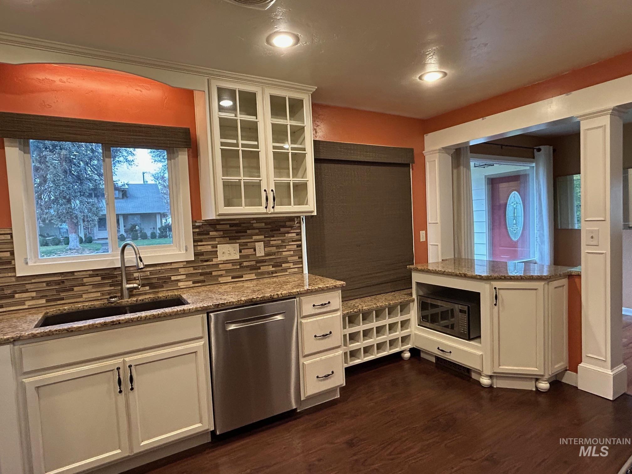112 17th Avenue Lewiston, ID 83501 - Photo 9 of 40 Kitchen featuring white cabinets, stainless steel appliances, light stone counters, glass insert cabinets, and backsplash