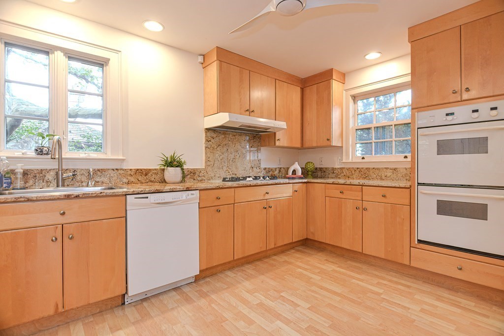 280 Common Street Belmont, MA 02478 - Photo 15 of 36 a kitchen with granite countertop white cabinets and white appliances