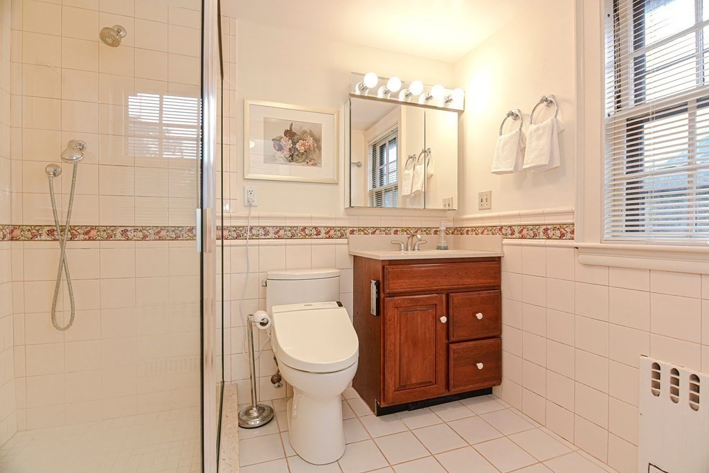 280 Common Street Belmont, MA 02478 - Photo 23 of 36 a bathroom with a toilet sink vanity and mirror