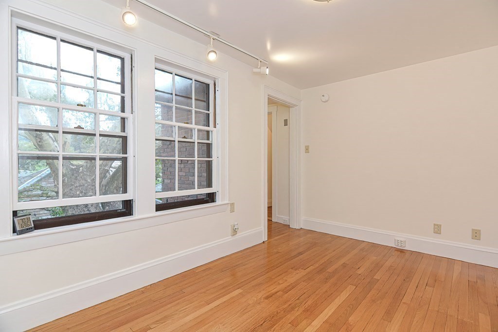 280 Common Street Belmont, MA 02478 - Photo 26 of 36 a view of an empty room with wooden floor and a window