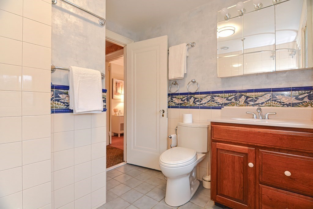 280 Common Street Belmont, MA 02478 - Photo 28 of 36 a bathroom with a toilet sink and mirror