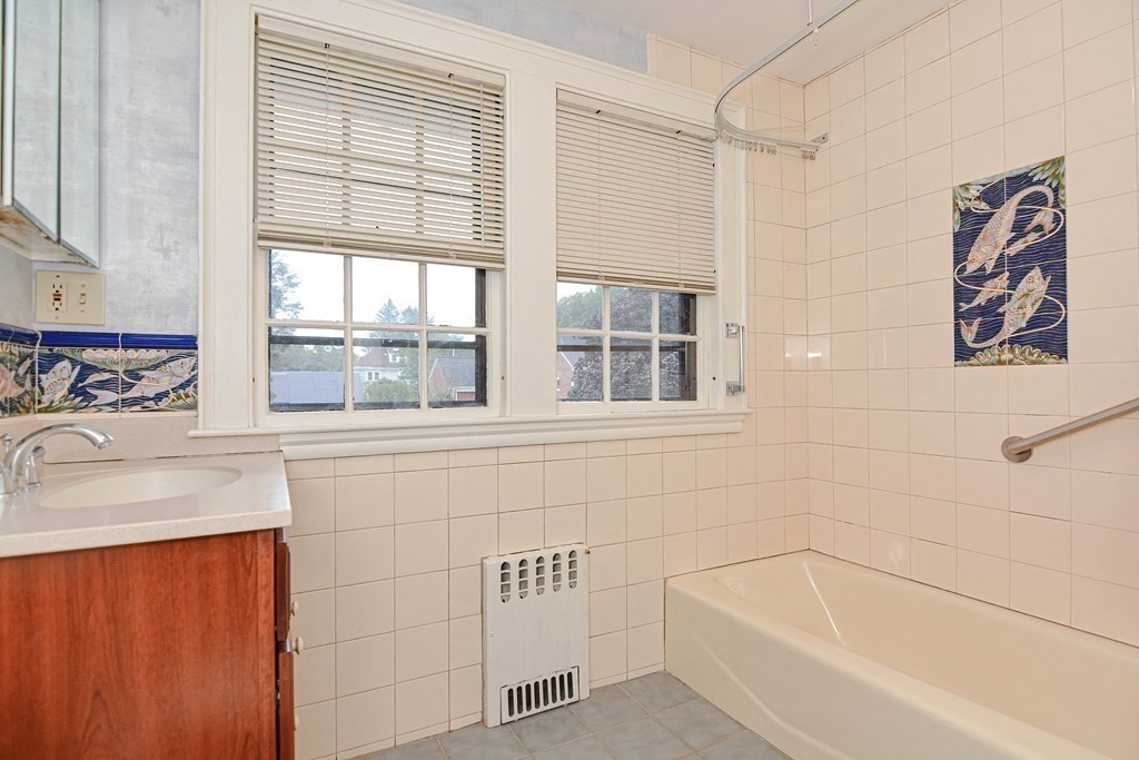 280 Common Street Belmont, MA 02478 - Photo 29 of 36 a bathroom with a tub sink and window