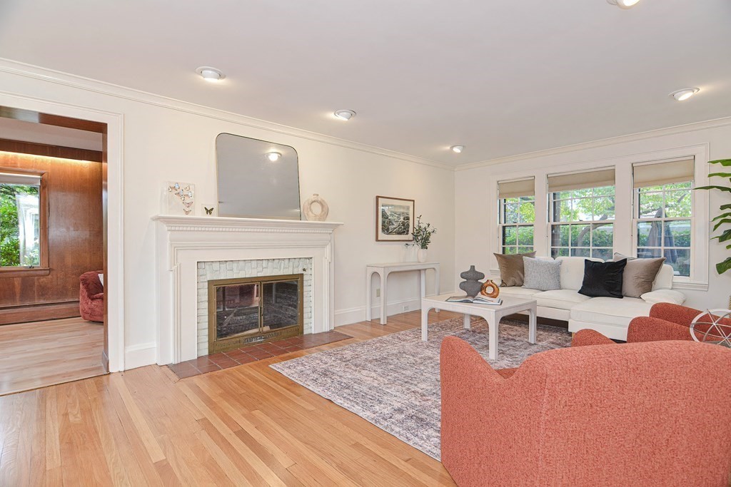 280 Common Street Belmont, MA 02478 - Photo 6 of 36 a living room with furniture a fireplace and a floor to ceiling window