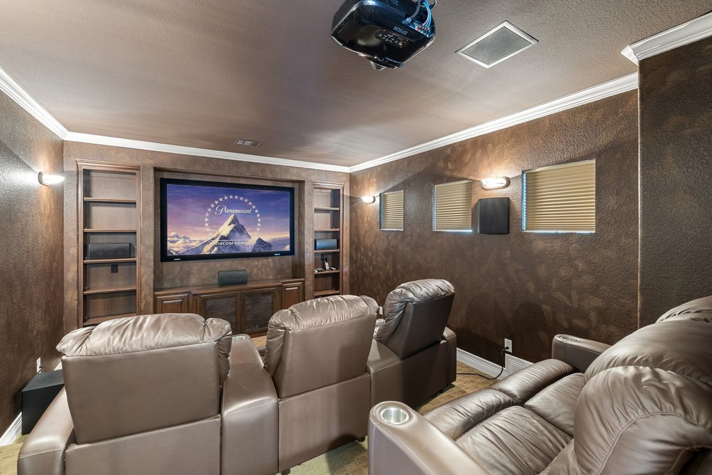 109 Largo Cove Austin, TX 78734 - Photo 22 of 40 Indulge in cinematic luxury within this dedicated media room, featuring built-in shelving and ample seating.