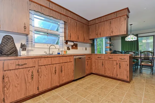 a kitchen with stainless steel appliances granite countertop a refrigerator stove and white cabinets