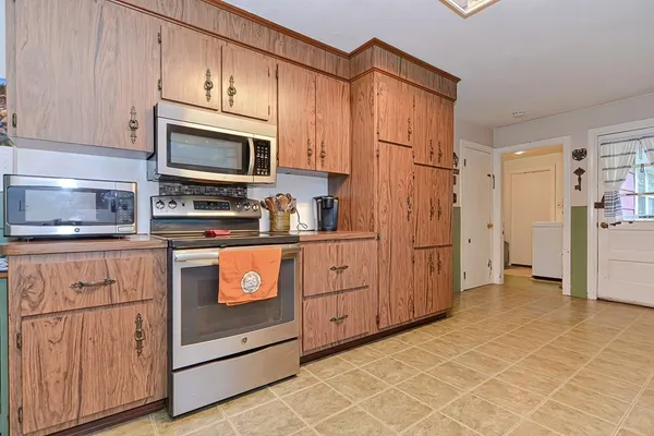 a view of a refrigerator and cabinets