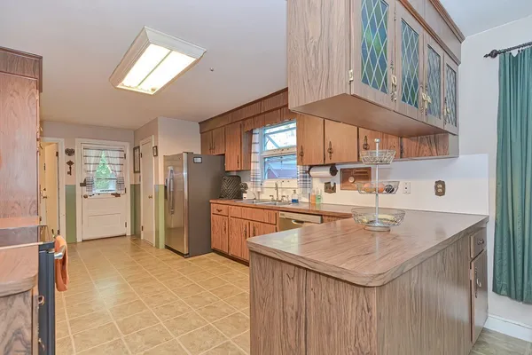 a kitchen with stainless steel appliances granite countertop a refrigerator stove and cabinets