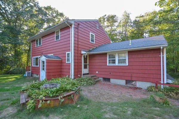 a view of a backyard with table and chairs and wooden fence